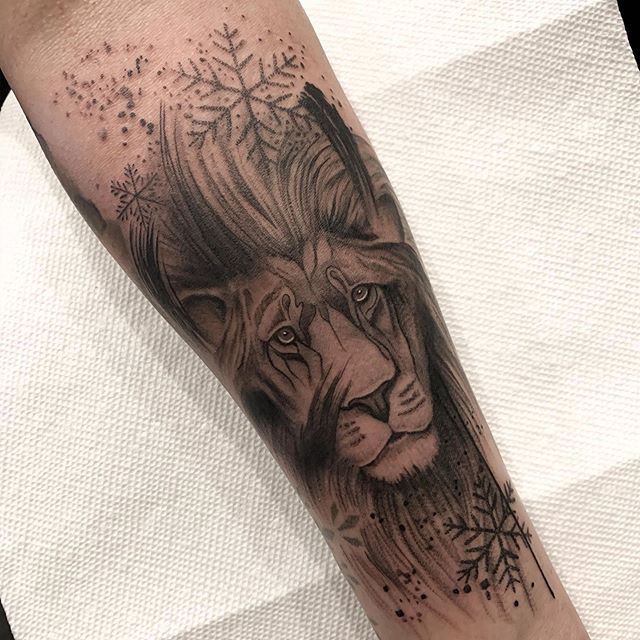 Lion head with Snowflakes Black and grey detailed tattoo created by Alan Lott of Sacred Mandala Studio - Tattoos, piercings and art gallery in Durham, NC.
